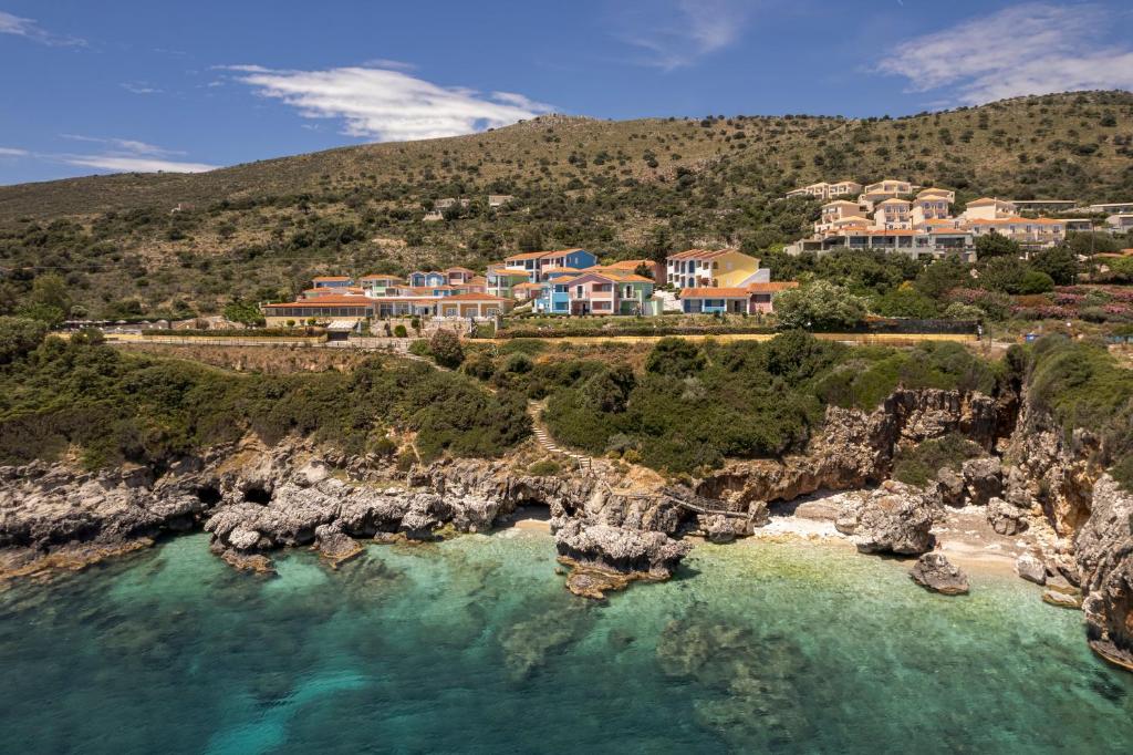 an aerial view of a resort on a rocky coast at Porto Skala Village Hotel in Skala