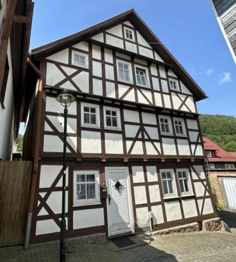 a half timbered house with a white door at Fewo am Wasserrad in Ruhla