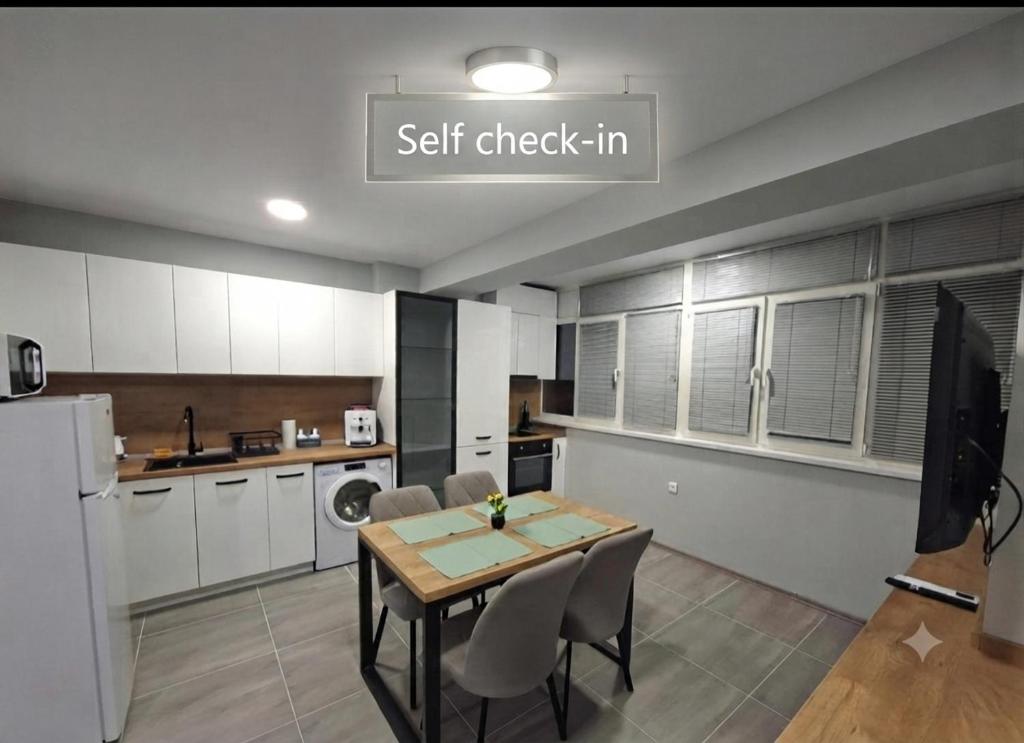 a kitchen with a table and chairs in a room at Numbers in Ruse