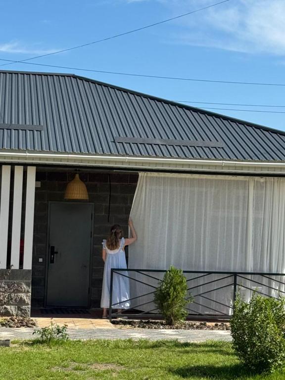 a woman standing in the doorway of a building at FishKa in Cholpon-Ata