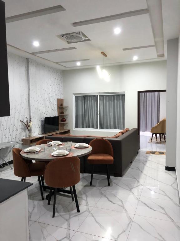 a living room with a table and a couch at 1 Bed Apartment in Murree in Murree