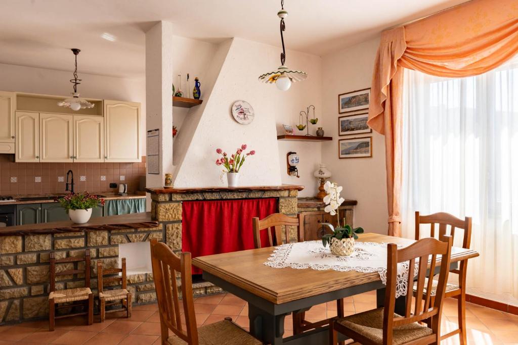 a kitchen and dining room with a table and chairs at Casa Konny in Gonnostramatza