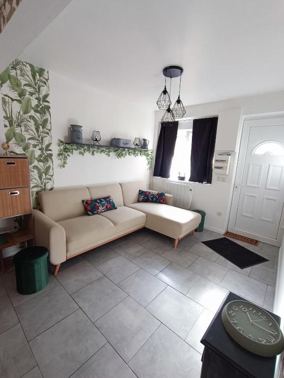 a living room with a couch and a table at La Courée d'Orchies in Loos