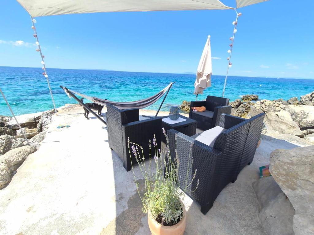 a swing on the beach with the ocean in the background at Apartment Max in Borovići