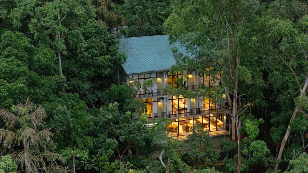 a house in the middle of the forest at Serenique Resort Kandy in Kandy