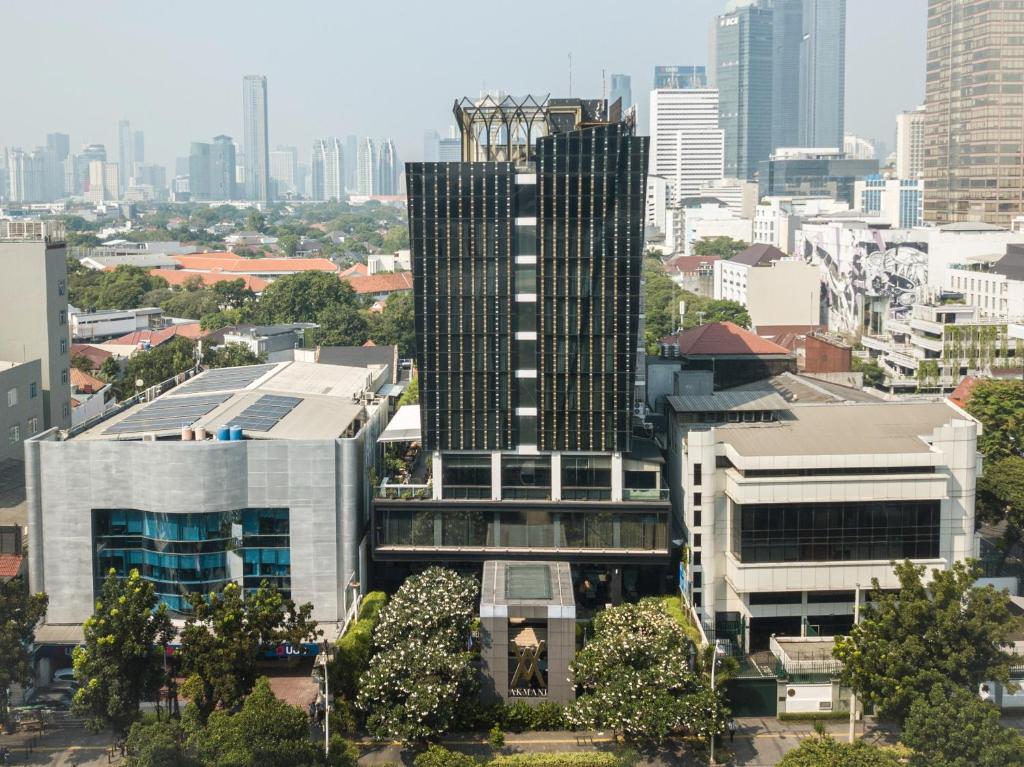 a view of a tall building in a city at Akmani Hotel Jakarta in Jakarta