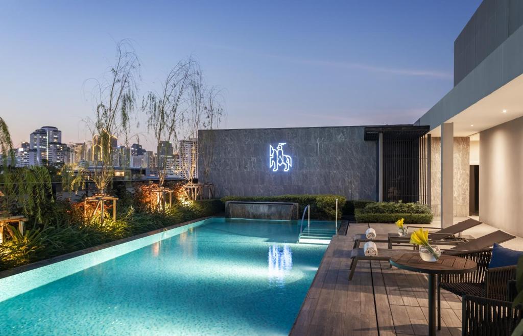 a swimming pool on top of a building at Walton Suites Sukhumvit in Bangkok