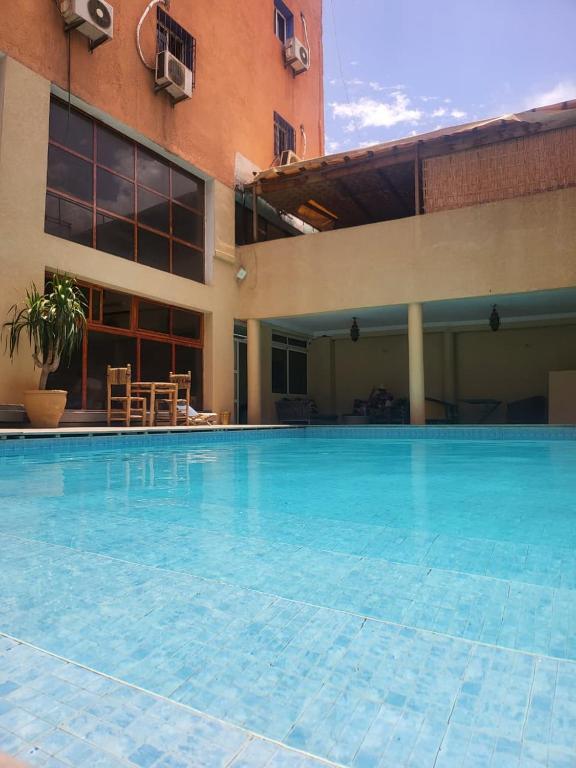 a large swimming pool in front of a building at Apart Hotel Larabi in Marrakesh