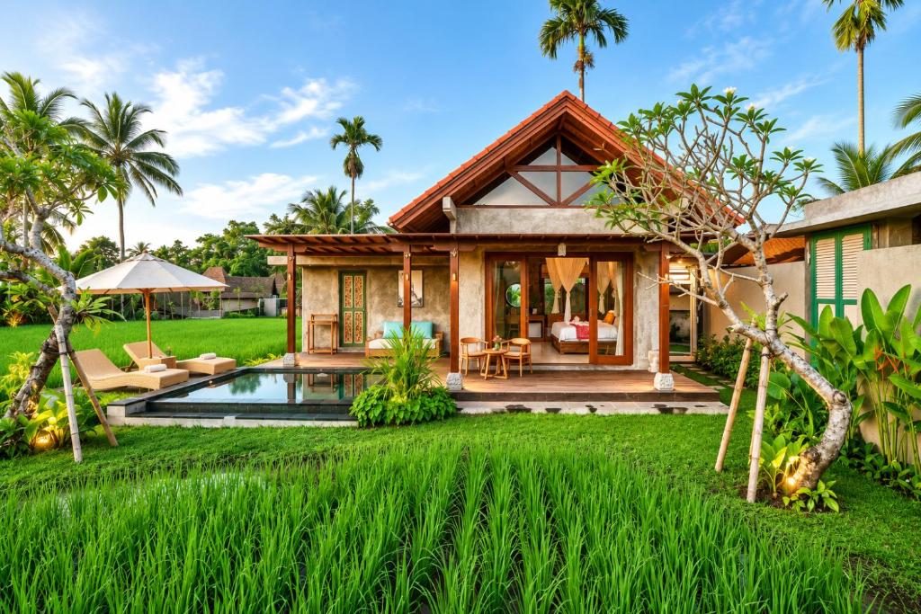 a villa with a pool and a house at The Asiki Sebatu in Tegalalang