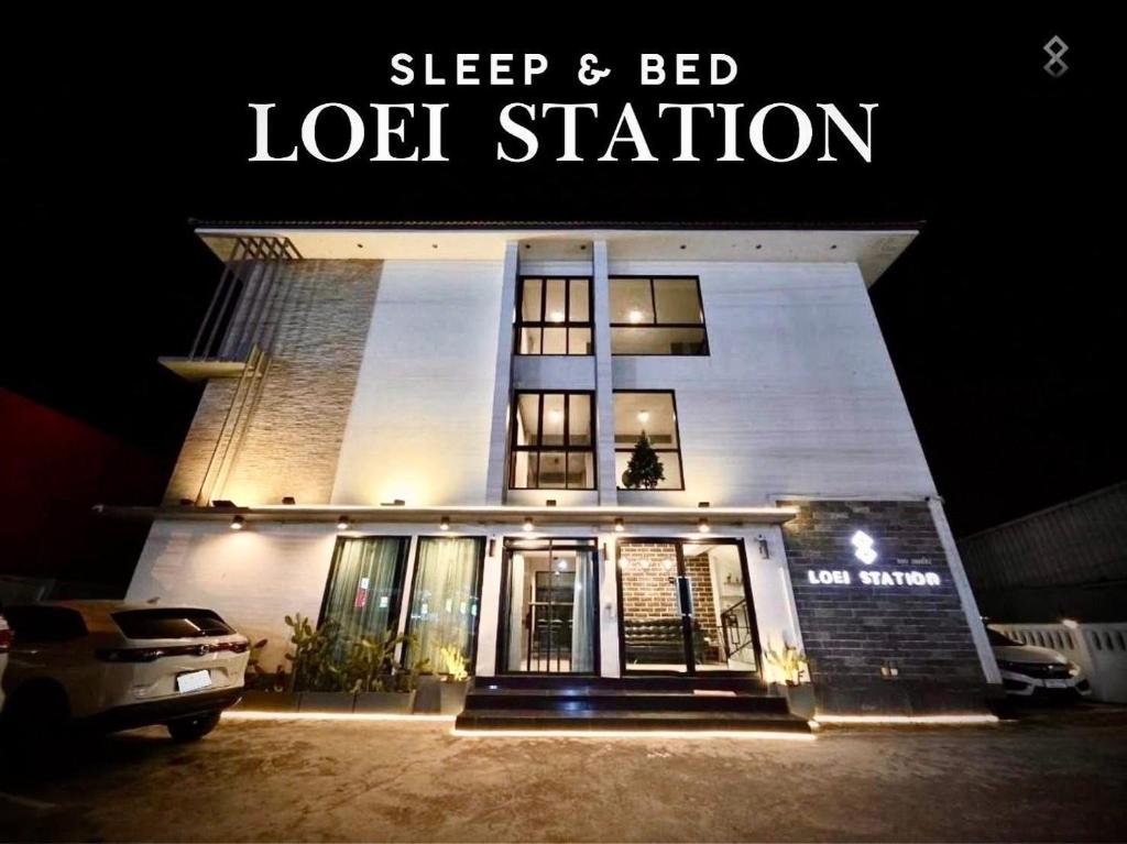 a building with a sign that reads sleep and bed lot station at Loei Station in Loei