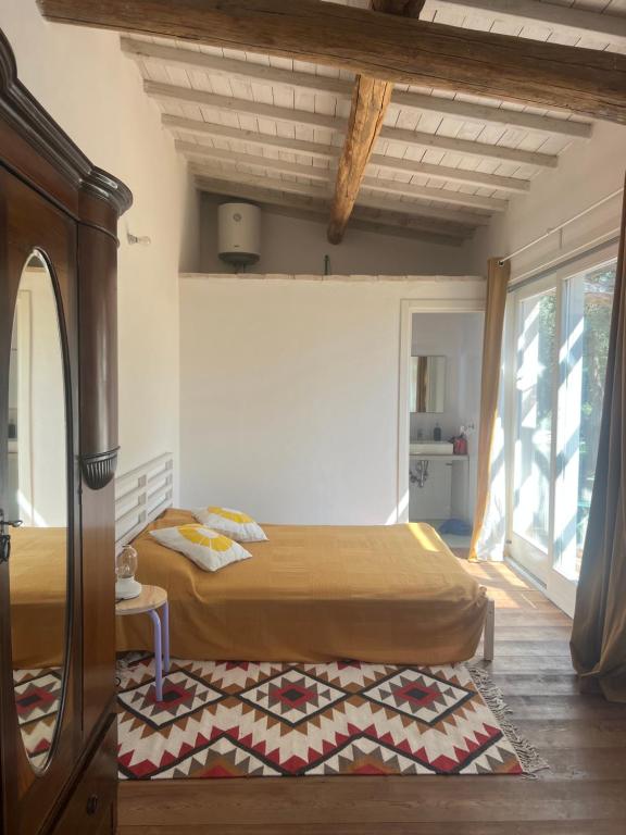 a bedroom with two beds and a large window at Il Respiro degli Ulivi in Viterbo