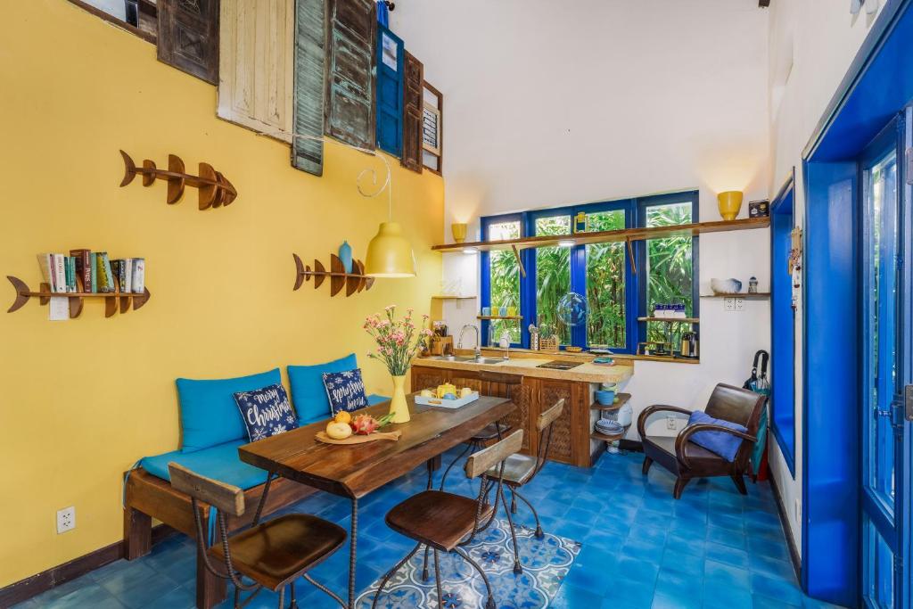 a living room with a blue couch and a table at Loft House 2BR Beachside An Bang Beach Hoi An by Beachside Boutique Homes in An Bàn (2)