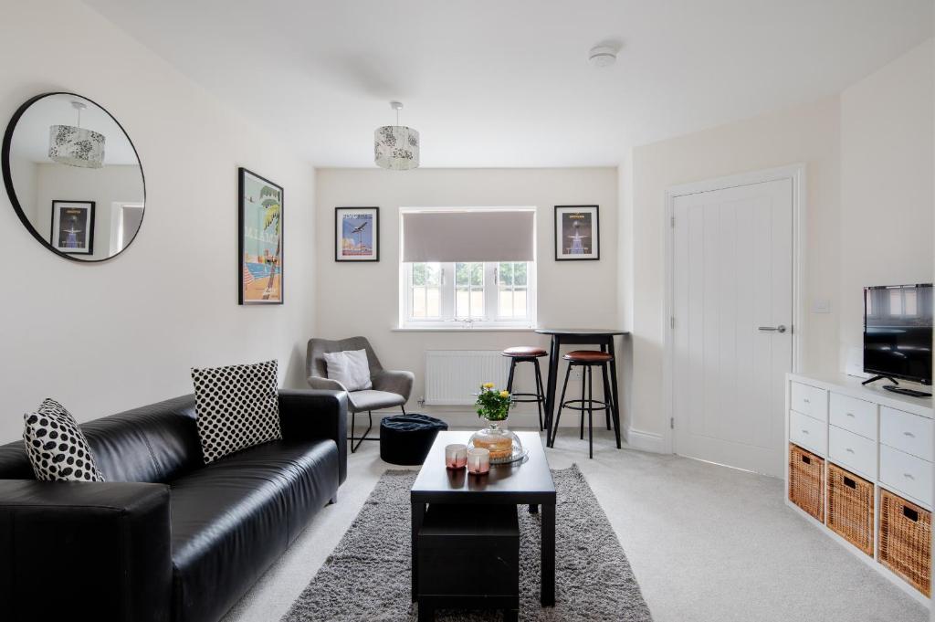a living room with a couch and a table at Finest Retreats - Field View in Brackley