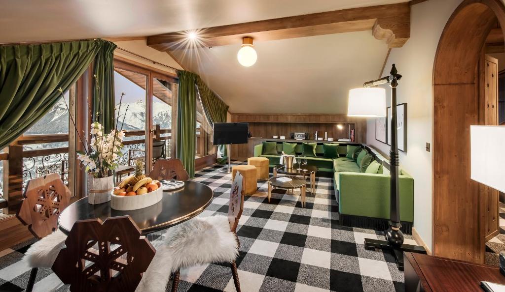 a living room with a couch and a table at Apogée Courchevel, Oetker Hotels in Courchevel