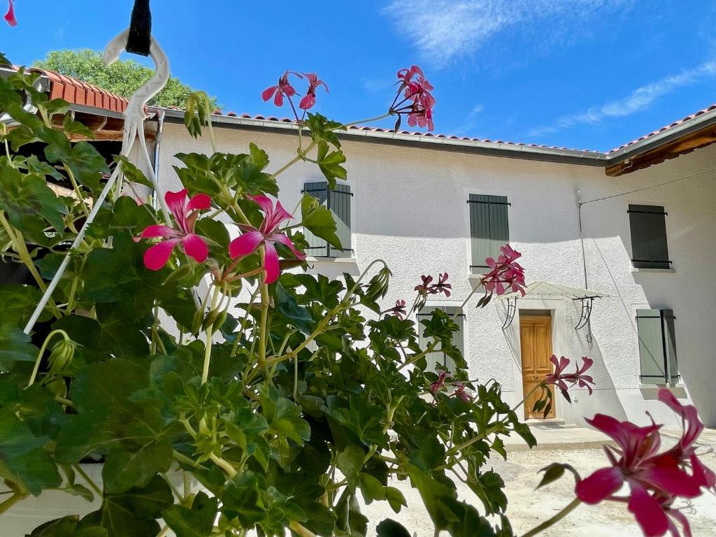 a house with pink flowers in front of it at La Promesse by Hillis in Marennes