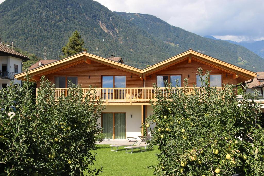 Casa de madera con balcón y árboles en Praitladhof en Lana