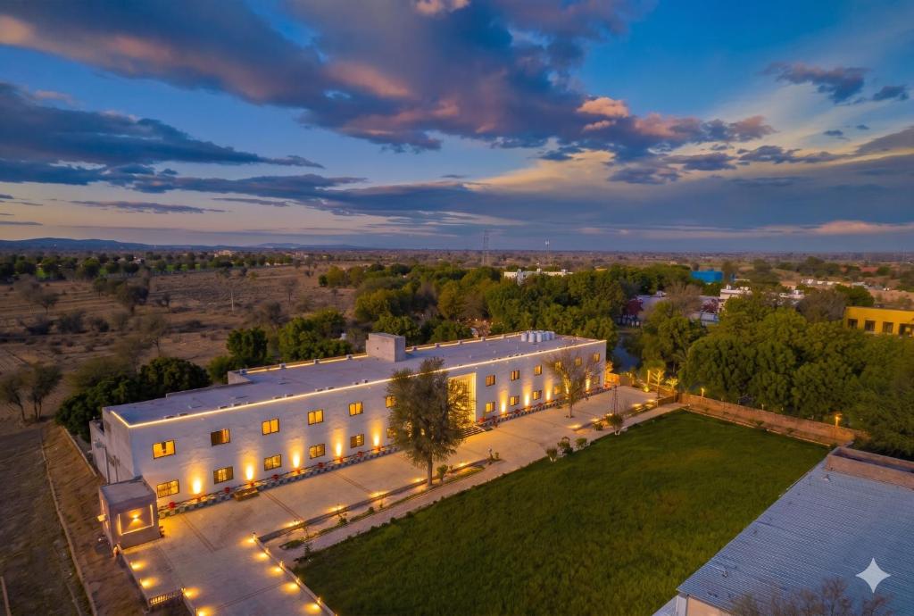 an aerial view of a large white building with lights at Hotel Aura in Bikaner