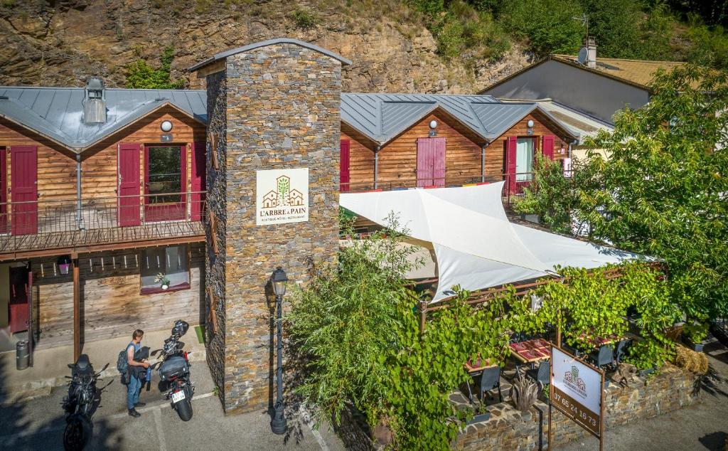 an overhead view of a building with a white umbrella at Hôtel Restaurant L'Arbre à Pain in Altier