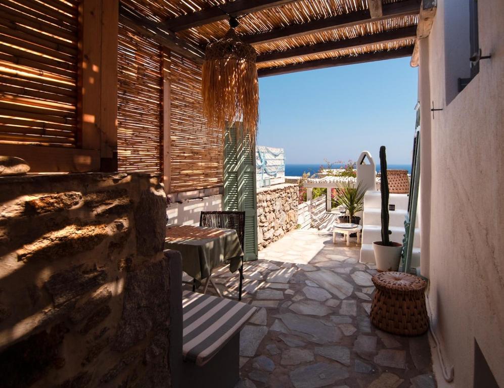 a patio with a bench and a view of the ocean at Naiada Home with Sea View in Mykonos