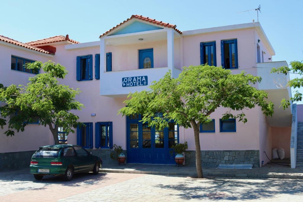 a house with a car parked in front of it at Orama Hotel in Sígrion