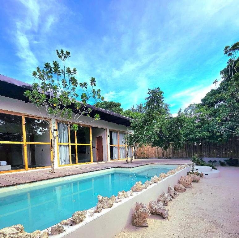 a swimming pool in front of a house at Wadi Residence in General Luna