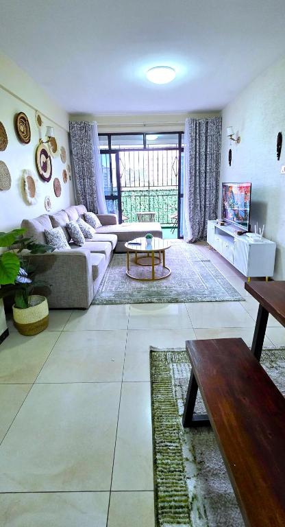 a living room with a couch and a table at The African Artisan 3BR Apartment in Nairobi