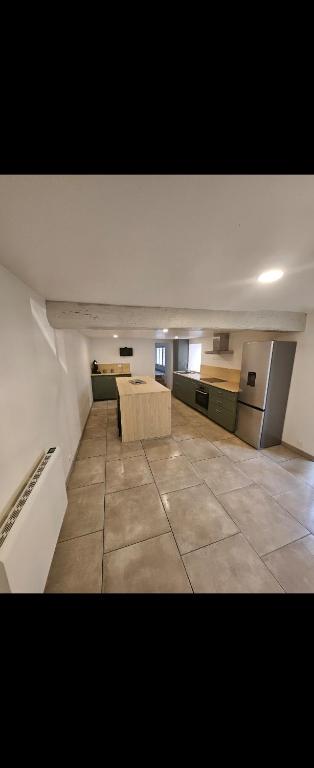 a large room with a kitchen and a living room at Maison de la passerelle in Parthenay