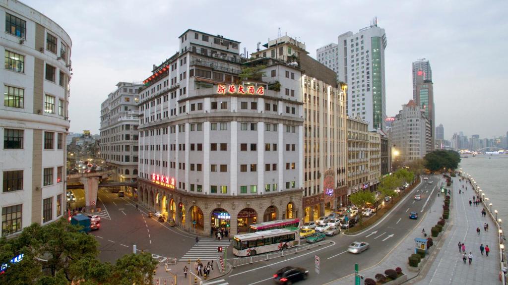 a building with a hotel sign on it in a city at Xin Hua Hotel Guangzhou in Guangzhou