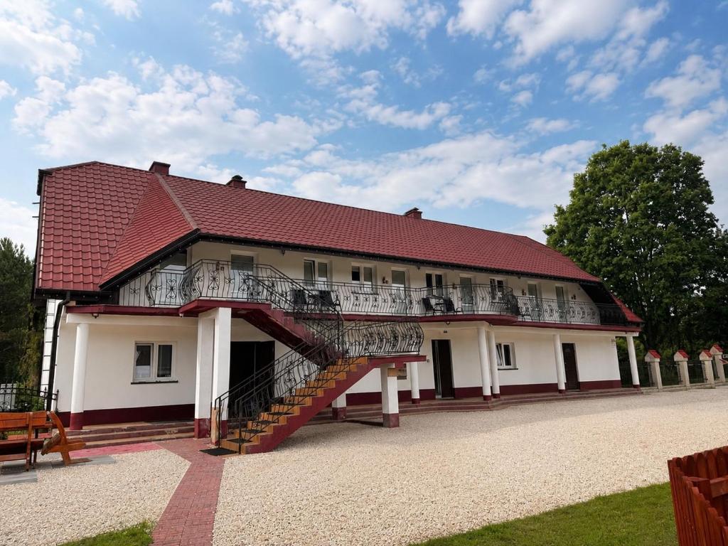 a building with a staircase on the side of it at U Gienka Pod Lasem in Święta Katarzyna