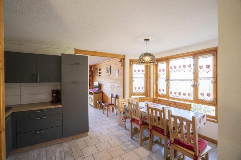 a kitchen and dining room with a table and chairs at Val Pierre in Châtel