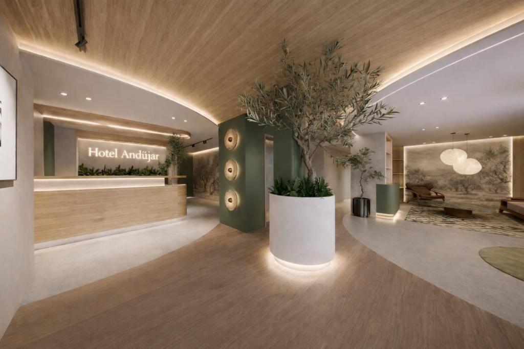 a lobby of a hotel with a potted plant at Hospedium GL Hotel Andújar in Andújar