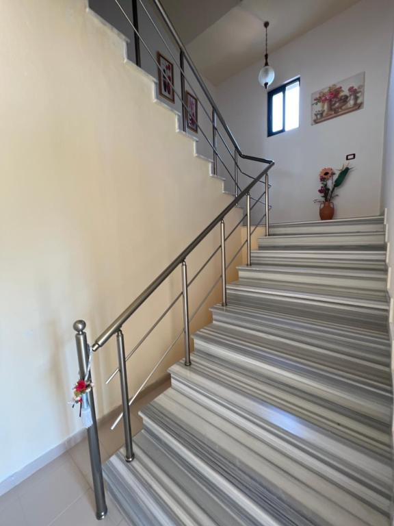 a staircase with metal railings in a building at Agron S in Vlorë