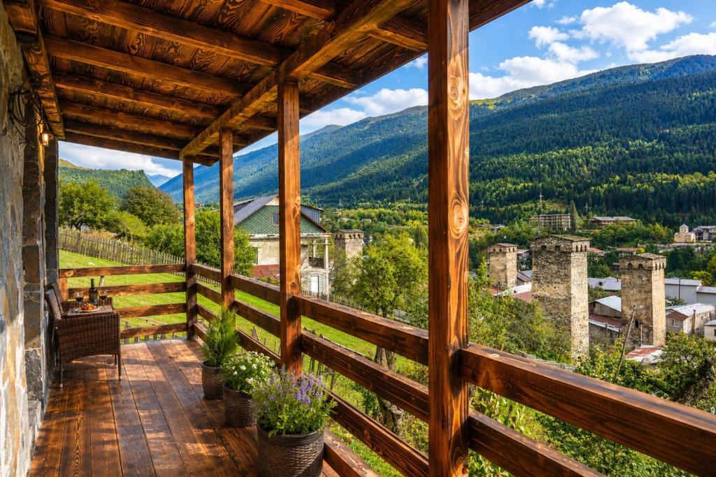 a view from the balcony of a house with mountains at Villa Dabderr Mestia in Mestia