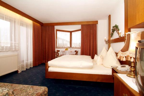 Postel nebo postele na pokoji v ubytování Sporthotel Pechtl