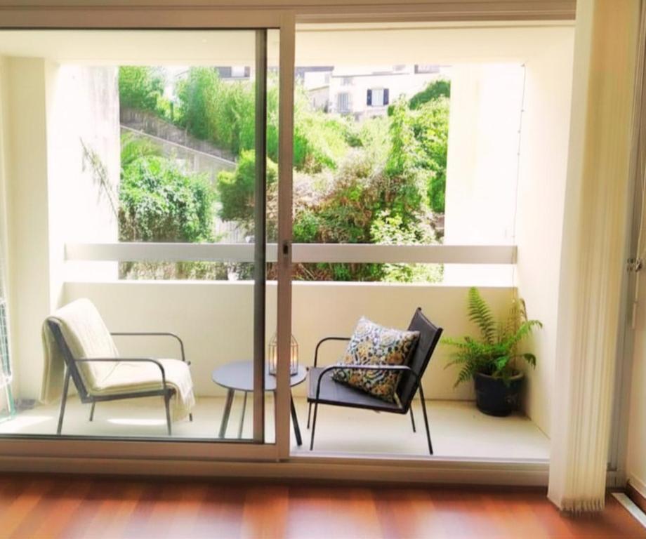 a balcony with two chairs and a table at A 200 m du centre historique, profitez d'un T2 spacieux avec balcon et parking privé in Quimper