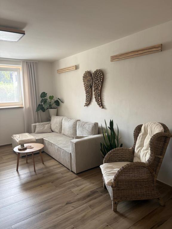 a living room with a couch and two chairs at Azyl na statku 5 in Pardubice