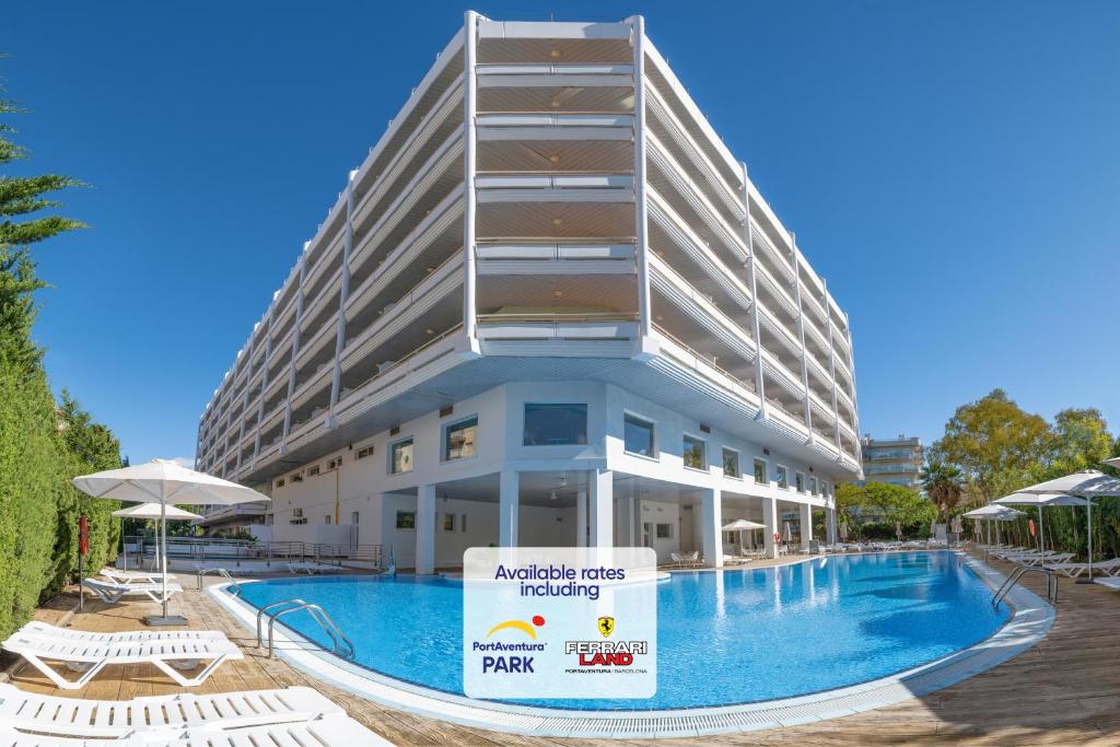 an apartment building with a swimming pool in front of it at Ponient Pirámide Salou by PortAventura World - Available rates with tickets to PortAventura Park & Ferrari Land in Salou