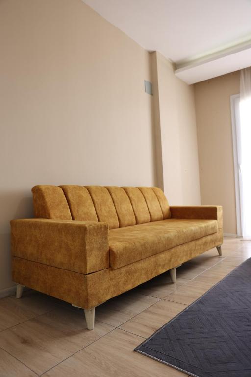 a brown couch sitting in a living room at Gold Apart Otel in Mersin
