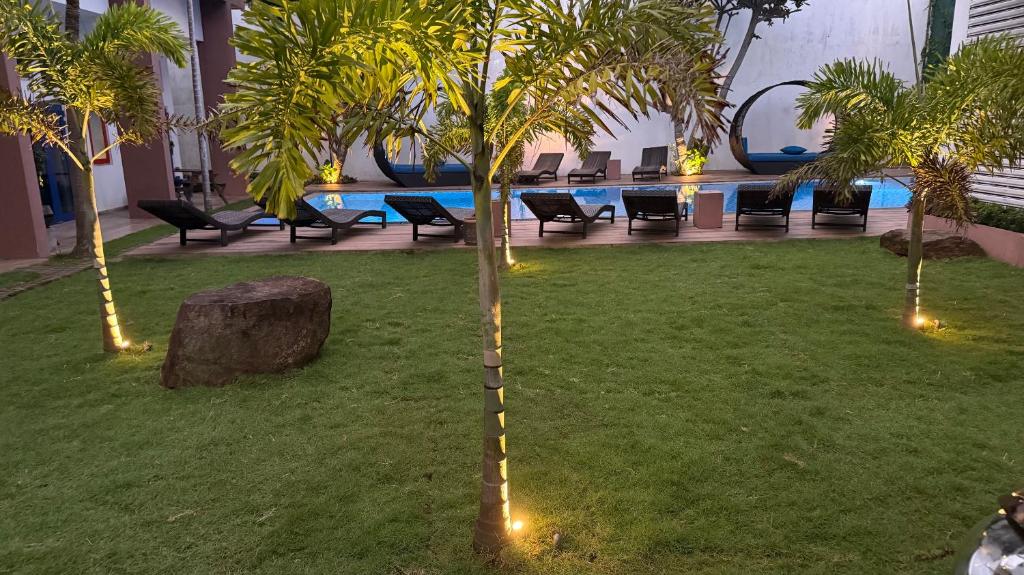 a resort with a pool and palm trees and lights at Hotel Cloud 9 Negombo in Negombo
