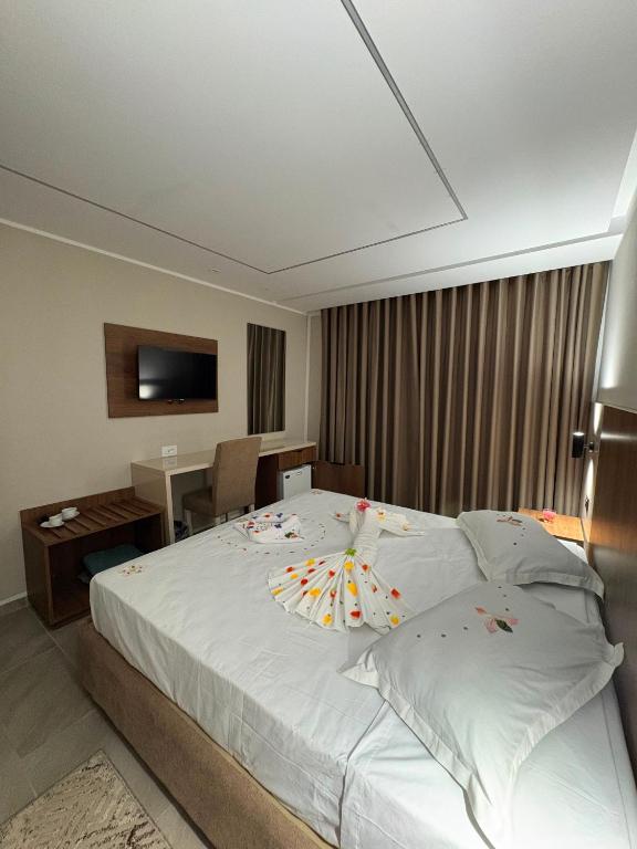 a bedroom with a large bed with an umbrella on it at Hôtel Passage in Tunis