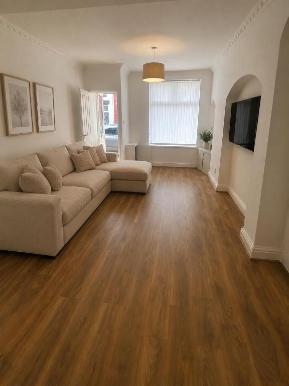 a living room with a couch and a television at Brennan stays contractor professional Friendly in Liverpool