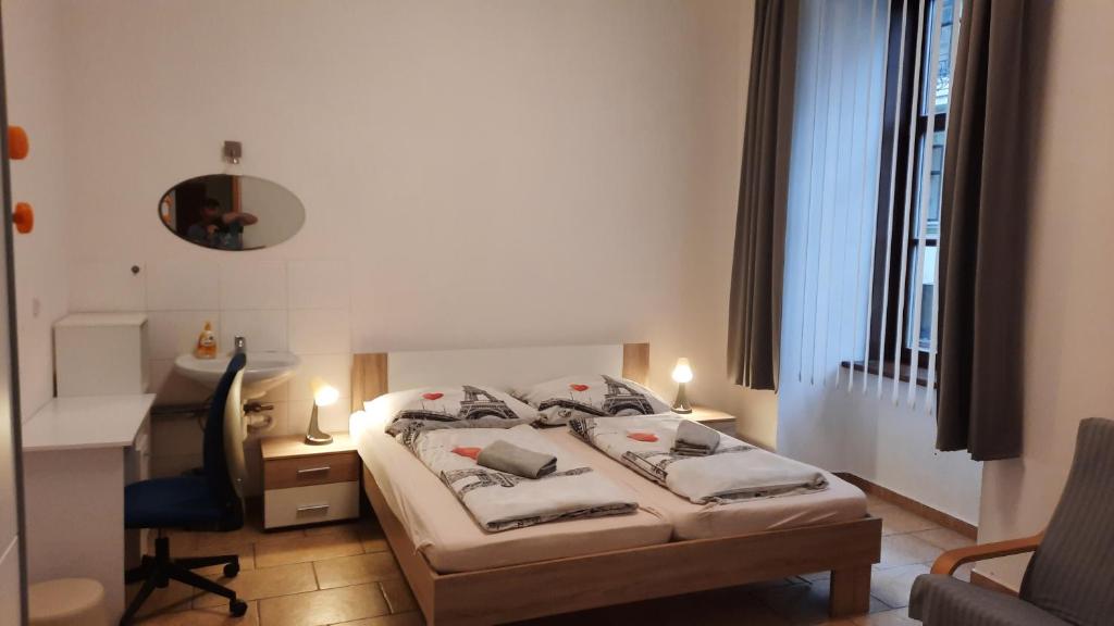 a bedroom with a bed and a desk and a chair at Relax apartmá Brno central - Brno střed in Brno