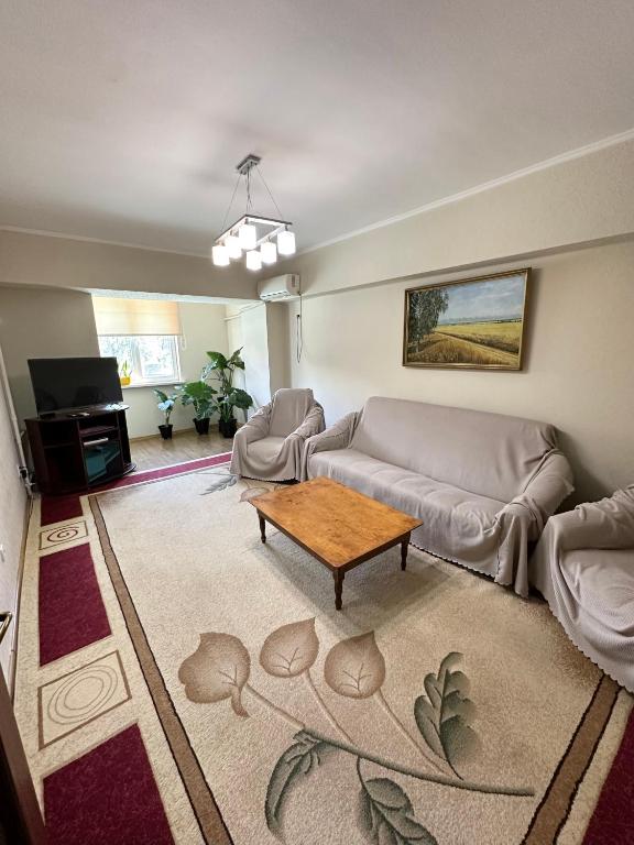 a living room with a couch and a coffee table at Bishkek Apartment Central in Bishkek
