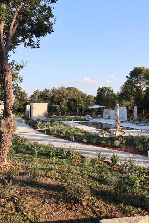 a park with a tree and a road at Quercia Private Nature Retreat in Maglie