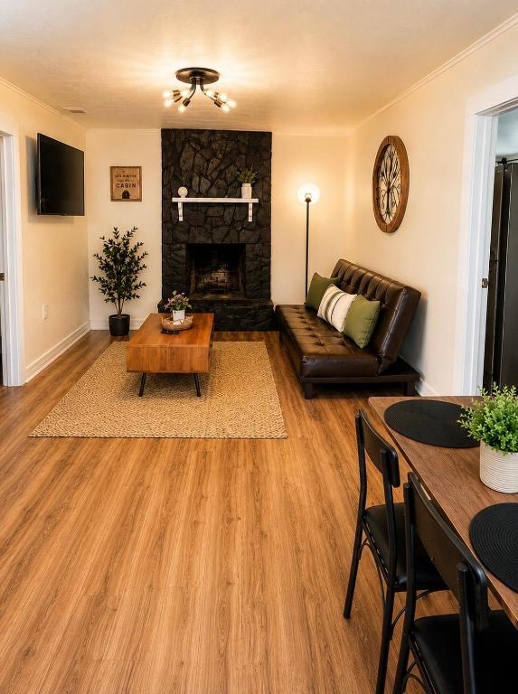 a living room with a couch and a fireplace at The Cozy Corner House in Kissimmee