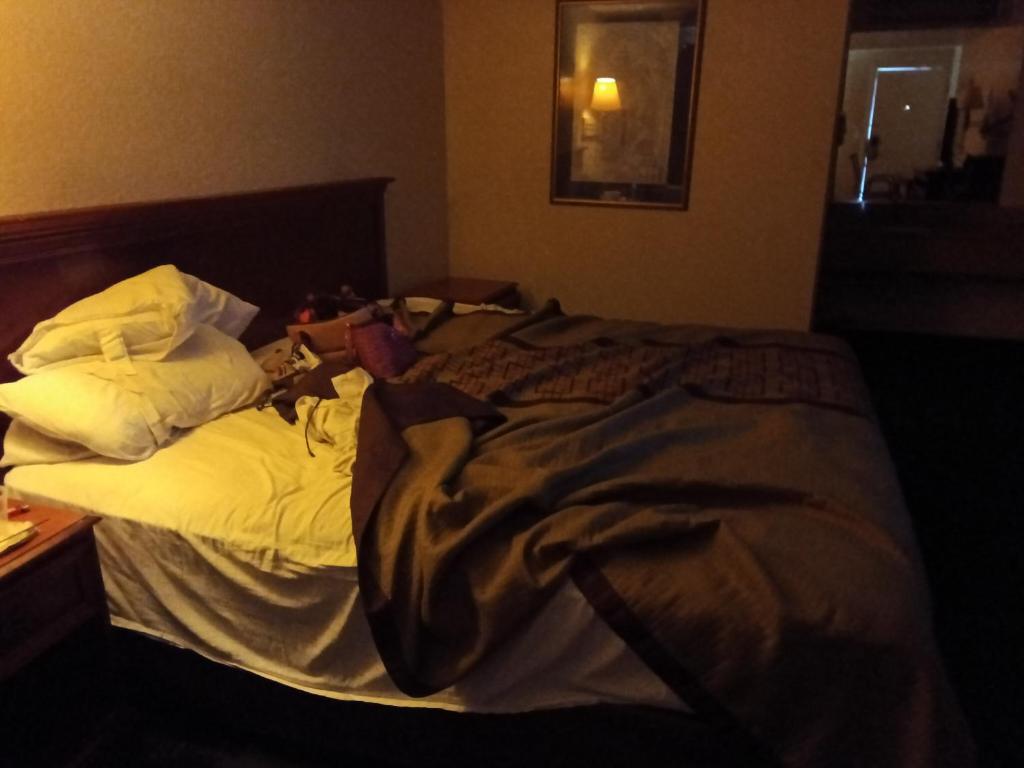 an unmade bed in a hotel room at Knights inn hotel in Jacksonville