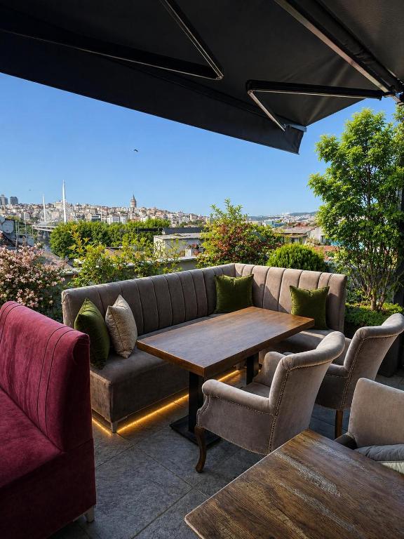 a patio with a couch and a table and chairs at Histavera Hotel in Istanbul