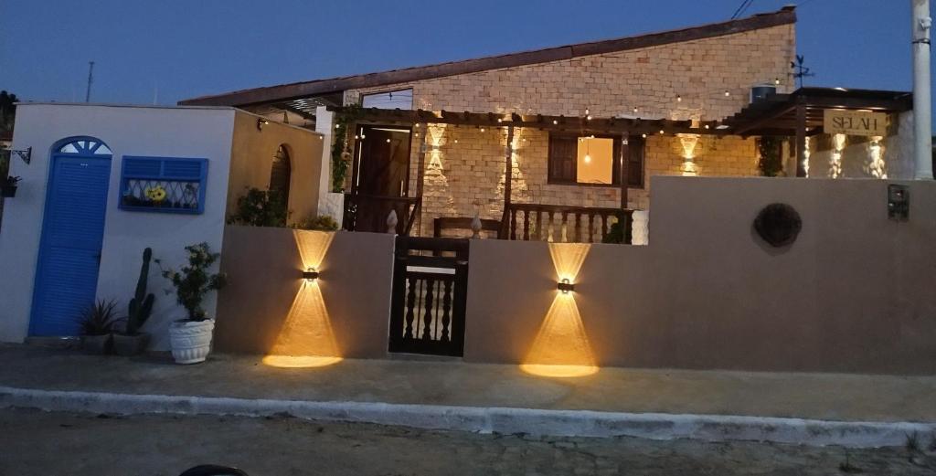 a house with lights on the side of it at Chale Selah Gameleiras in Monte das Gameleiras