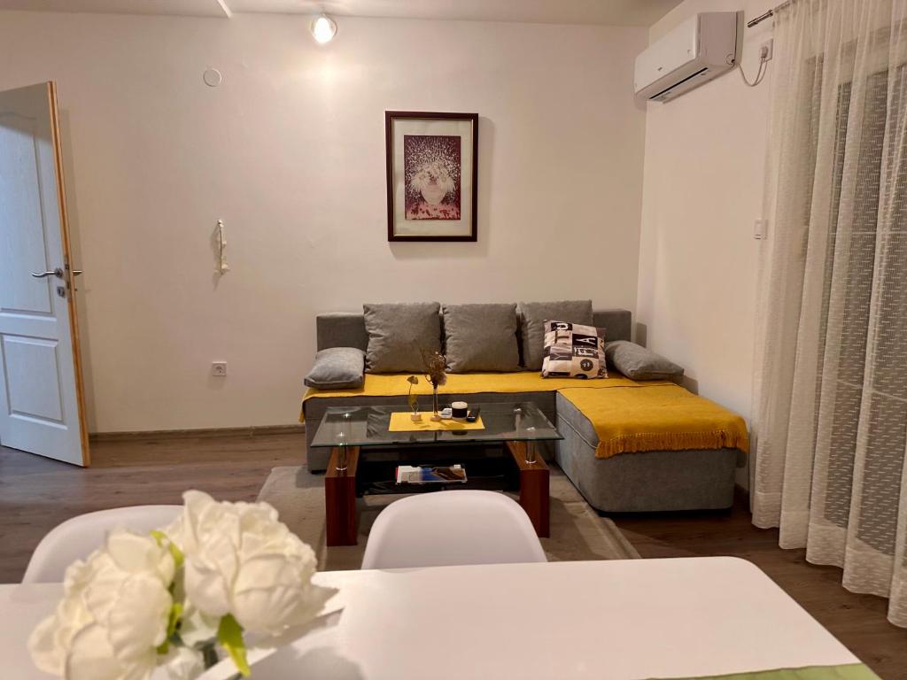 a living room with a bed and a table and chairs at Liberty Apartments in Cetinje