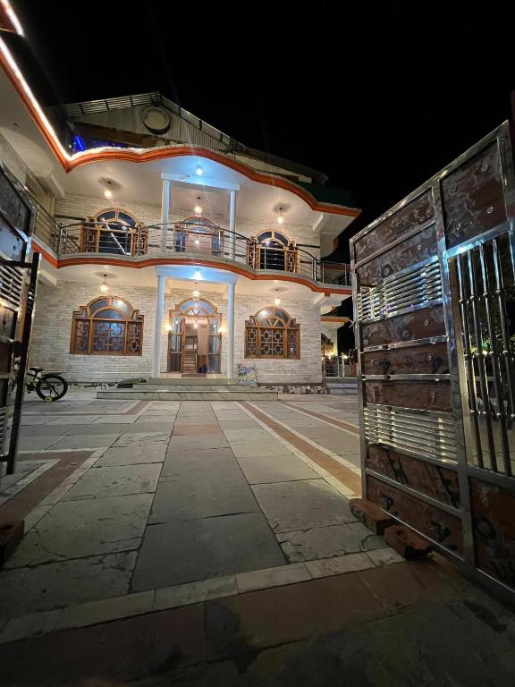 a large white building with a balcony on top of it at Whitestone PULGA in Kalgha